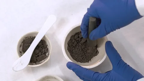 Scientist manually by hands mills a soil sample for experiments Stock Footage 115101606