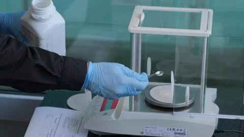 Scientist Measuring Substance on Laboratory Scale Stock Footage 303762545