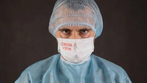 Scientist in a medical mask with the word "coronavirus" Stock Footage