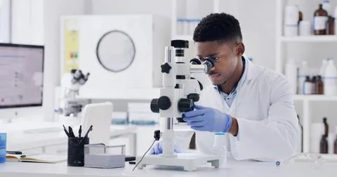 Scientist, microscope and exam with black man in lab for forensic research .. Fotos de archivo