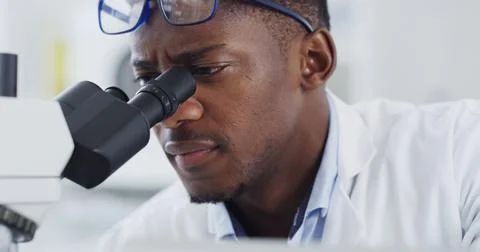 Scientist, microscope or study with black man in lab for forensic research .. Stock Photos
