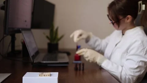 Scientist monitors virus testing data Stock Footage 337571364