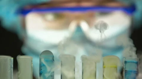 Scientist observing boiling process in test tubes, secret laboratory research Stock Footage 104562706