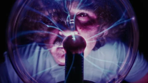 Scientist Observing High Voltage Lightning Discharges Inside Plasma Ball Stock Footage 337769357