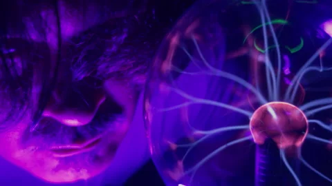 Scientist Observing High Voltage Lightning Discharges Inside Plasma Ball Stock Footage 337771684