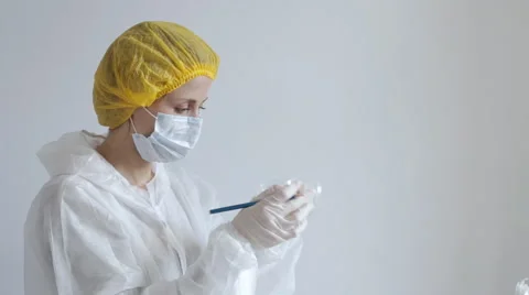 Scientist observing pills Stock Footage 64367907