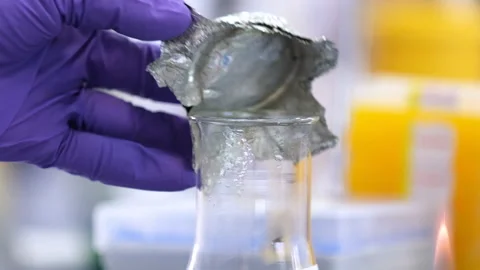 The scientist opens a chemical flask Stockbeeldmateriaal 171747799