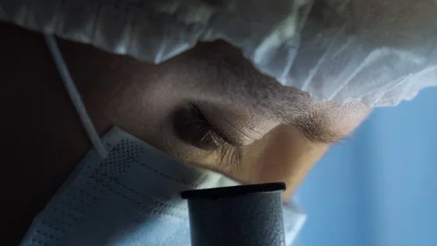 Scientist or doctor looking through a microscope in a laboratory, close-up Stock Footage 116111636