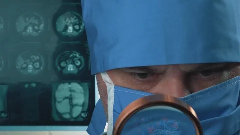Scientist or doctor working in the operating room with magnifier. Video stock 124267166