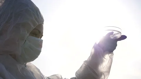 Scientist or ecology expert in protective costume with water samples probe for Stock Footage 171558066
