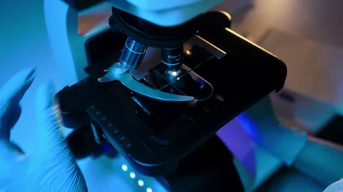Scientist or researcher examines samples of a modern microscope. Stock Footage 271619595