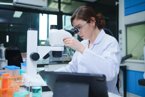 Scientist Performing Microscopy Analysis in Advanced Laboratory Stock Photos