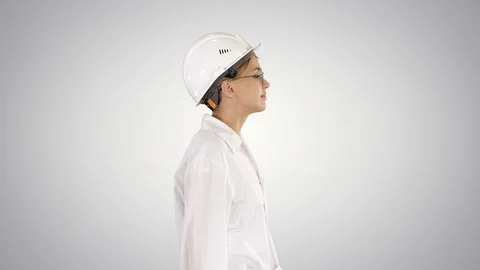 Scientist physicist woman walking in lab coat and hardhat on gradient background Stock Footage 109404517