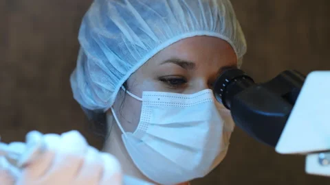 Scientist pipettes a sample of liquid onto the glass of a microscope. Stock Footage 302180307