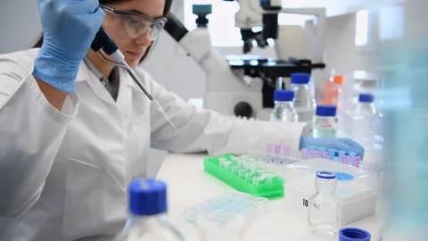 Scientist pipetting a sample into a vial ready for analytical testing in the the Stock Footage 129902027