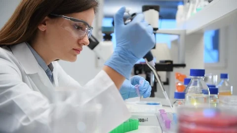 Scientist pipetting a sample into a vial ready for analytical testing in the the Stock Footage 129902738