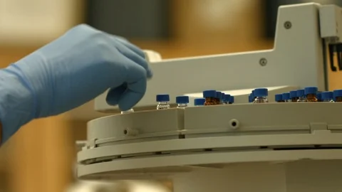 Scientist places small test tube in a holder Stock Footage 106901676