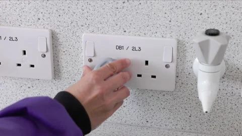 Scientist plugging in microscope uk plug socket switching on Stock Footage 232007758