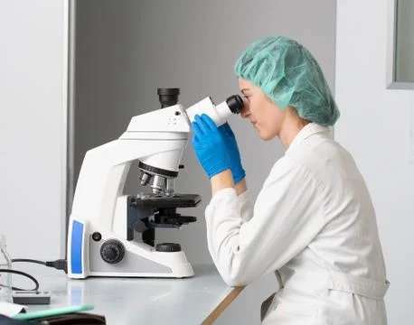 Scientist portrait at microscope 스톡 사진