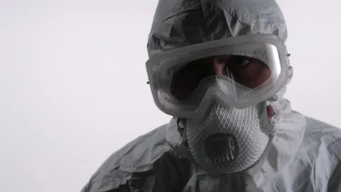 A scientist portraite in PPE looking into the camera on a white background Stock Footage 297968669