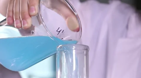 Scientist pour liquid to conduct medical trial Stock Footage