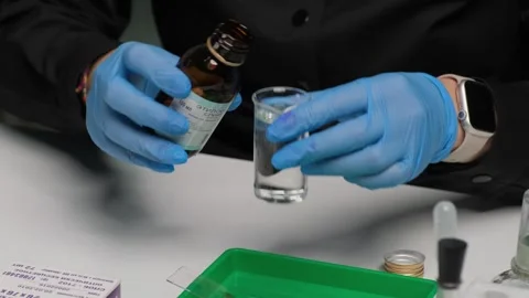Scientist Pouring Chemical Solution in Laboratory Test Stock Footage 306319324