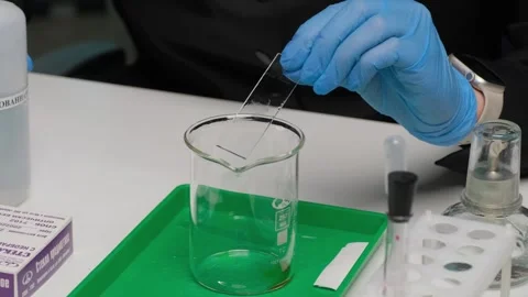 Scientist Pouring Liquid into Beaker Stock Footage 303370412