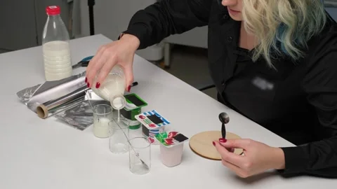 Scientist Pouring Milk for Laboratory Analysis Stock Footage 306322964