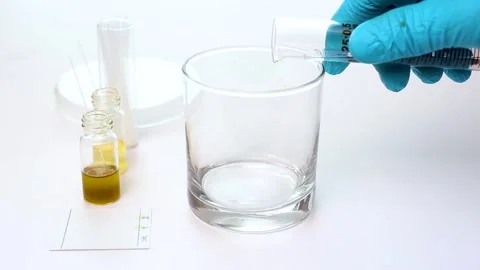 Scientist Pouring Prepared Mobile Phase Solvent from Graduated Cylinder int.. Stock Footage 323139360
