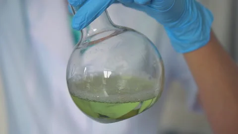 Scientist pouring red liquid in test tubes in a laboratory Stock Footage 95850688