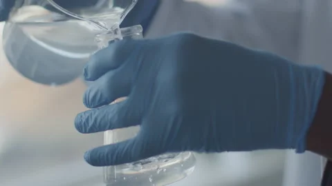 Scientist Pours Liquid Into Beaker Stock Footage 208750603