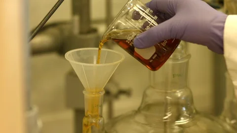 Scientist pours a liquid Stock Footage 106898938