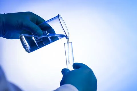 Scientist pours liquid Stock Photos