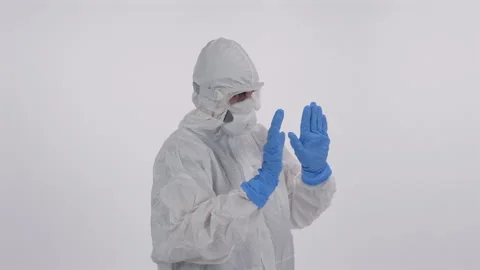 Scientist in PPE backs off on white background Stock Footage 297969049