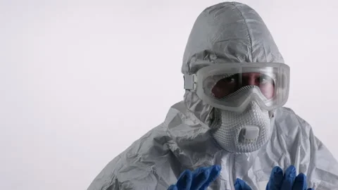 Scientist in PPE backs off on white background Stock Footage 297969217