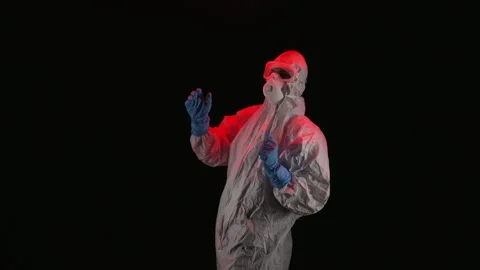 Scientist in PPE dancing in a dark room Stock Footage 299922188