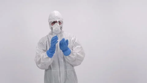 A scientist in PPE doing different things on a white background Stock Footage 297965537