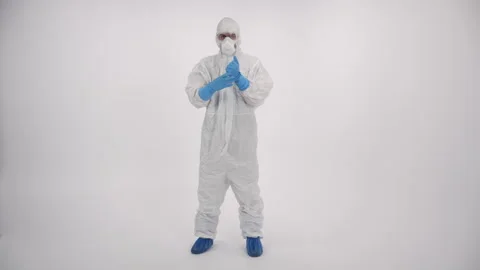 A scientist in PPE doing different things on a white background Stock Footage 297966461