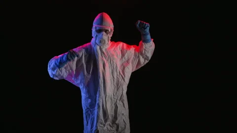 Scientist in PPE doing multiple poses in a dark room Video stock 299922594