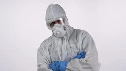 A scientist in PPE looking into the camera on a white background Stock Footage 297967009