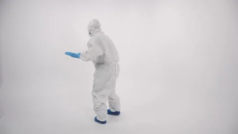 A scientist in PPE showing a 'no access' sign on a white background Stock Footage 297966827