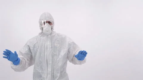 A scientist in PPE showing a 'no access' sign on a white background Stock Footage 297967231