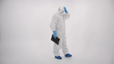 A scientist in PPE verifying a medical record on a white background Stock Footage 297967970