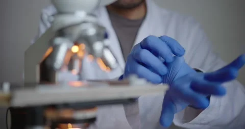 Scientist Preparing for Laboratory Work with Microscope Stock Footage 300362257