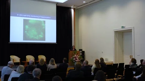 Scientist Presenting Research Data on Screen at Medical Conference Event Stock Footage 334776325