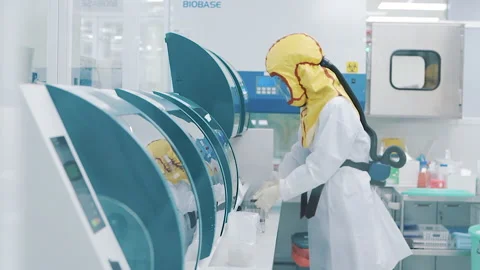 Scientist in protective clothing working in laboratory Video stock 158528443