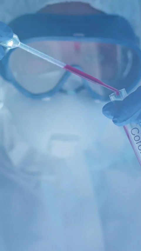 Scientist in Protective Gear Handling Test Tube with Blood Sample Stock Footage 315281243
