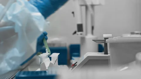 Scientist in protective suit and gloves research chemical or biological samples Stock Footage 148057257