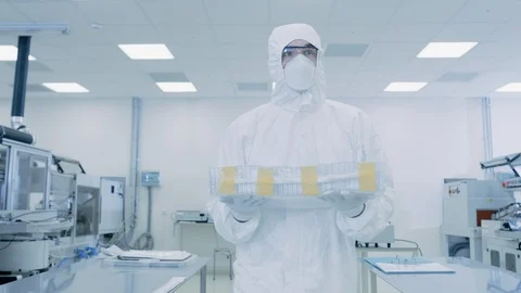 Scientist in Protective Suit Carries Case with Product Case Through Laboratory. Video stock 93223973