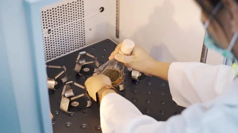 Scientist put the erlenmeyer flask into shaker machine in laboratory Video stock 158912938